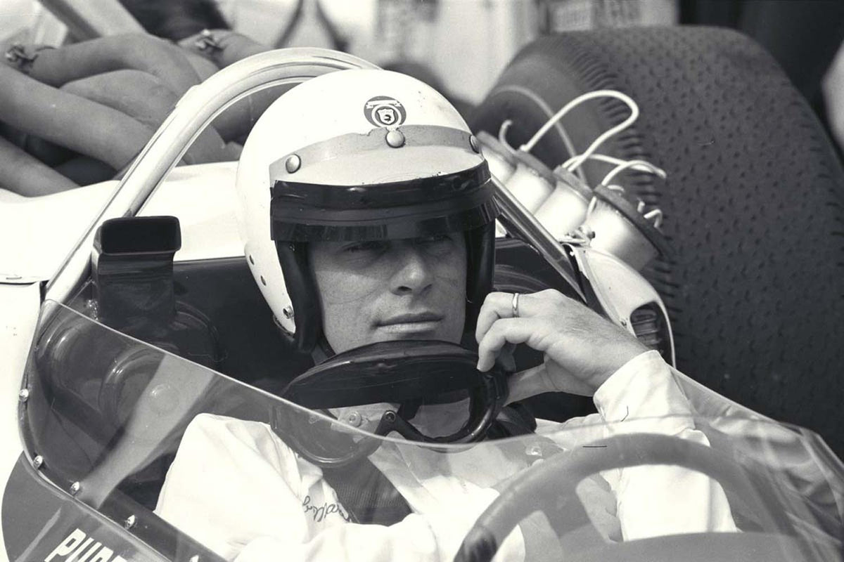 Ford Motor Company archival image documenting 1964 Indianapolis 500 Pre Race Indiana Bobby Marshman sits in the cockpit of his record setting car.