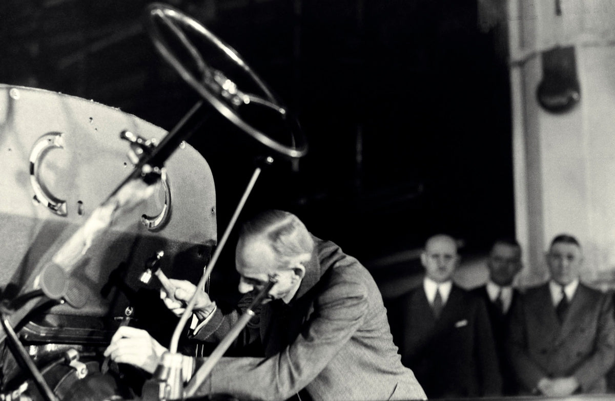 1932 Henry Ford stamping serial number into first