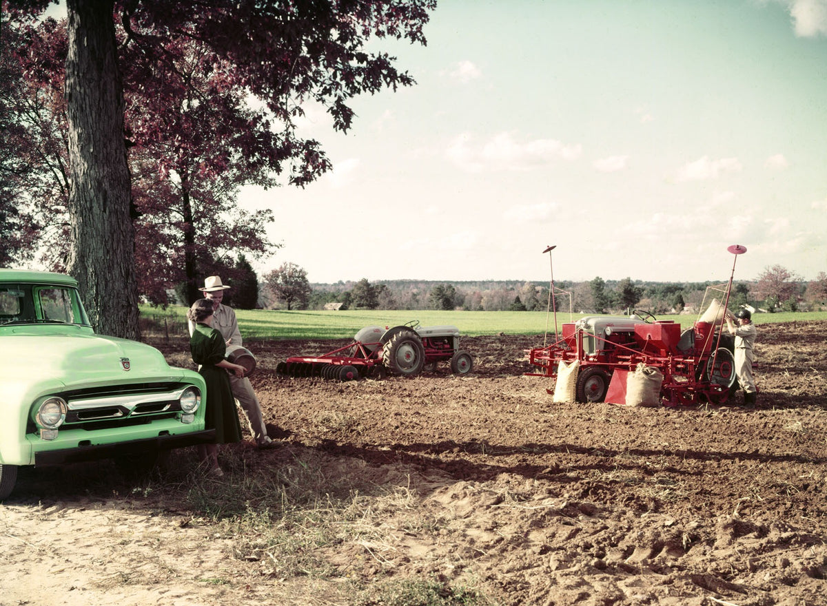 1956 Ford F-100 pickup with tractors and implement