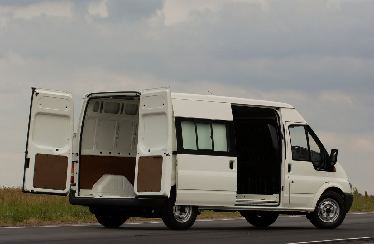 This archival image documents the 2003 Ford Transit Mark IV side view with open doors on scenic road and is preserved in the Ford Heritage Vault as part of Ford Motor Company's historic photographic archive. Free for personal, non-commercial use. ...