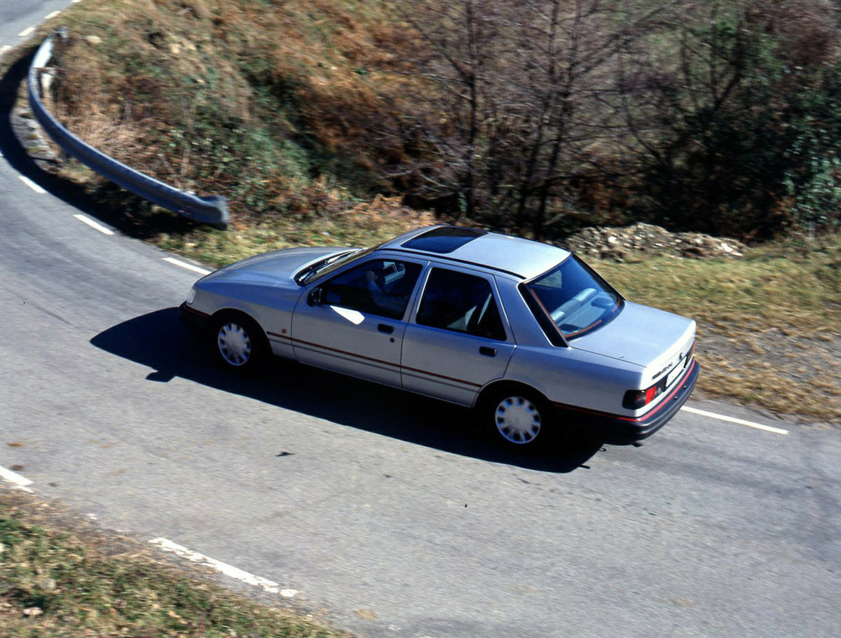 This archival image documents the 1990 Ford Sierra 90.5 LHD rear view action shot on scenic road in Spain and is preserved in the Ford Heritage Vault as part of Ford Motor Company's historic photographic archive. Free for personal, non-commercial ...