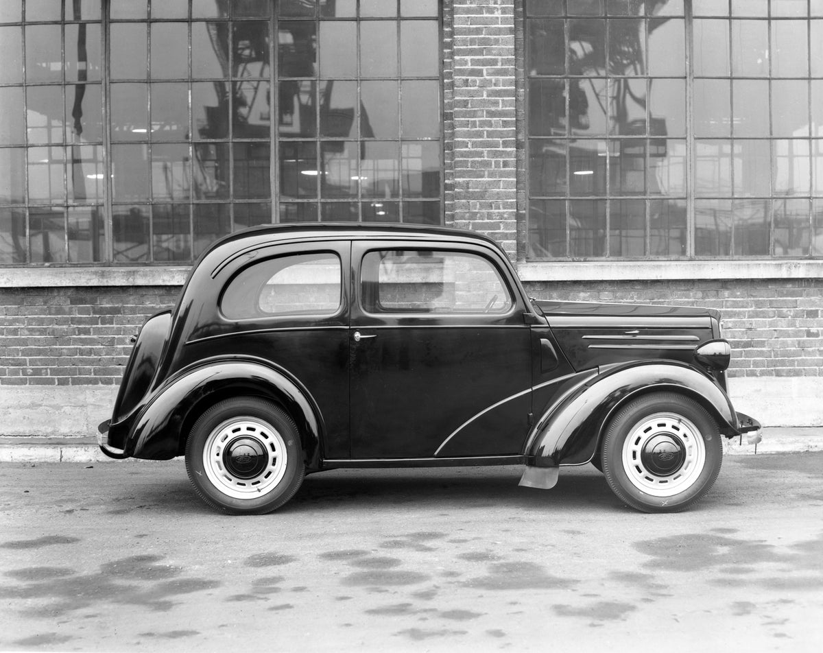 This archival image documents the 1946 Ford Anglia E04A side view and is preserved in the Ford Heritage Vault as part of Ford Motor Company's historic photographic archive. Free for personal, non-commercial use. Ford Heritage Vault reference AR-20...