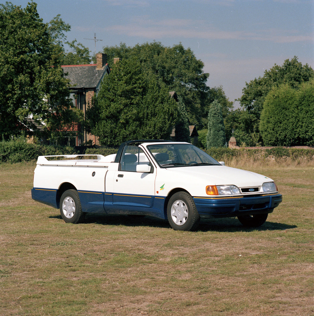 This archival image documents the 1989 Ford P-100 in scenic field with trees and is preserved in the Ford Heritage Vault as part of Ford Motor Company's historic photographic archive. Free for personal, non-commercial use. Ford Heritage Vault refe...