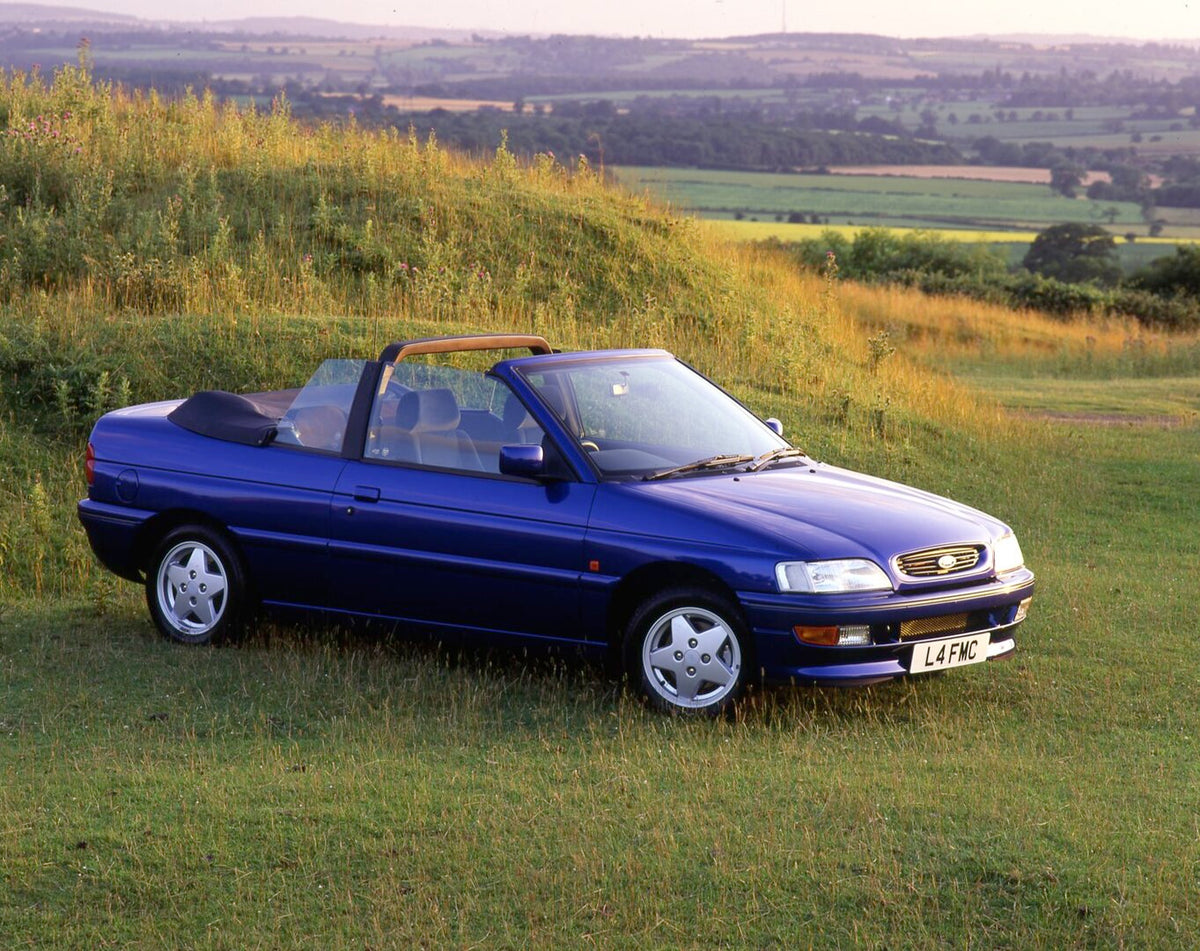 This archival image documents the 1993 Ford Escort Mark V Cabriolet in scenic field and is preserved in the Ford Heritage Vault as part of Ford Motor Company's historic photographic archive. Free for personal, non-commercial use. Ford Heritage Vau...
