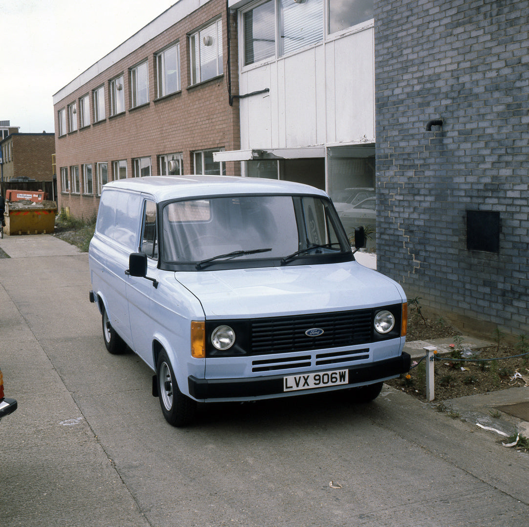This archival image documents the 1981 Ford Transit Mark II Popular Van in front of building and is preserved in the Ford Heritage Vault as part of Ford Motor Company's historic photographic archive. Free for personal, non-commercial use. Ford Her...