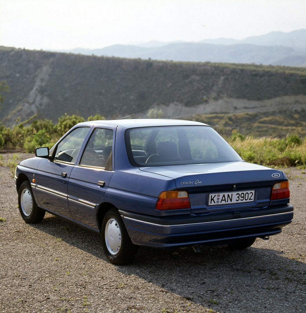 This archival image documents the 1990 Ford Orion Mark III rear view on scenic road and is preserved in the Ford Heritage Vault as part of Ford Motor Company's historic photographic archive. Free for personal, non-commercial use. Ford Heritage Vau...