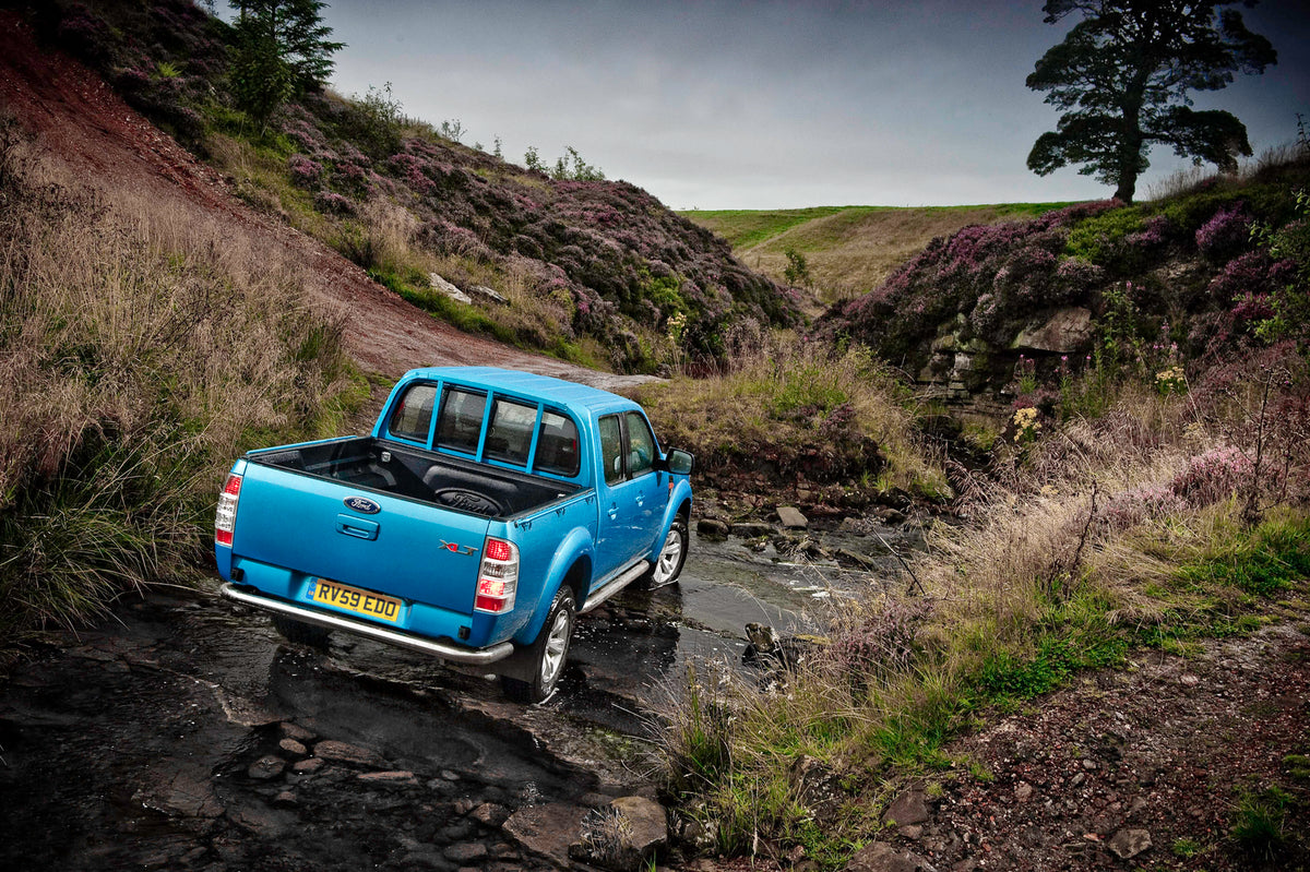 This archival image documents the 2009 Ford Ranger XLT rear view in scenic rocky riverbed and is preserved in the Ford Heritage Vault as part of Ford Motor Company's historic photographic archive. Free for personal, non-commercial use. Ford Herita...