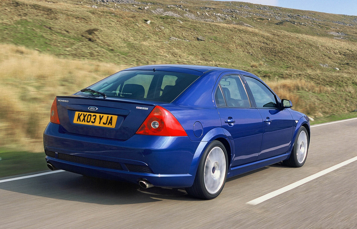 This archival image documents the 2003 Ford Mondeo Mark II rear view action shot on scenic road and is preserved in the Ford Heritage Vault as part of Ford Motor Company's historic photographic archive. Free for personal, non-commercial use. Ford ...