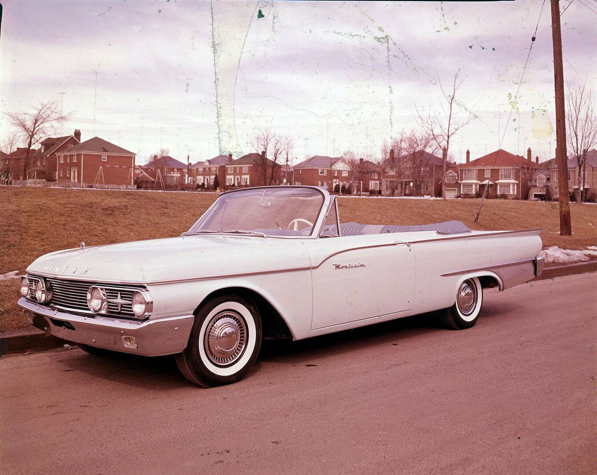 This archival image documents the 1960 Meteor Montcalm Convertible on scenic road with houses AR-2007-5 and is preserved in the Ford Heritage Vault as part of Ford Motor Company's historic photographic archive. Free for personal, non-commercial us...