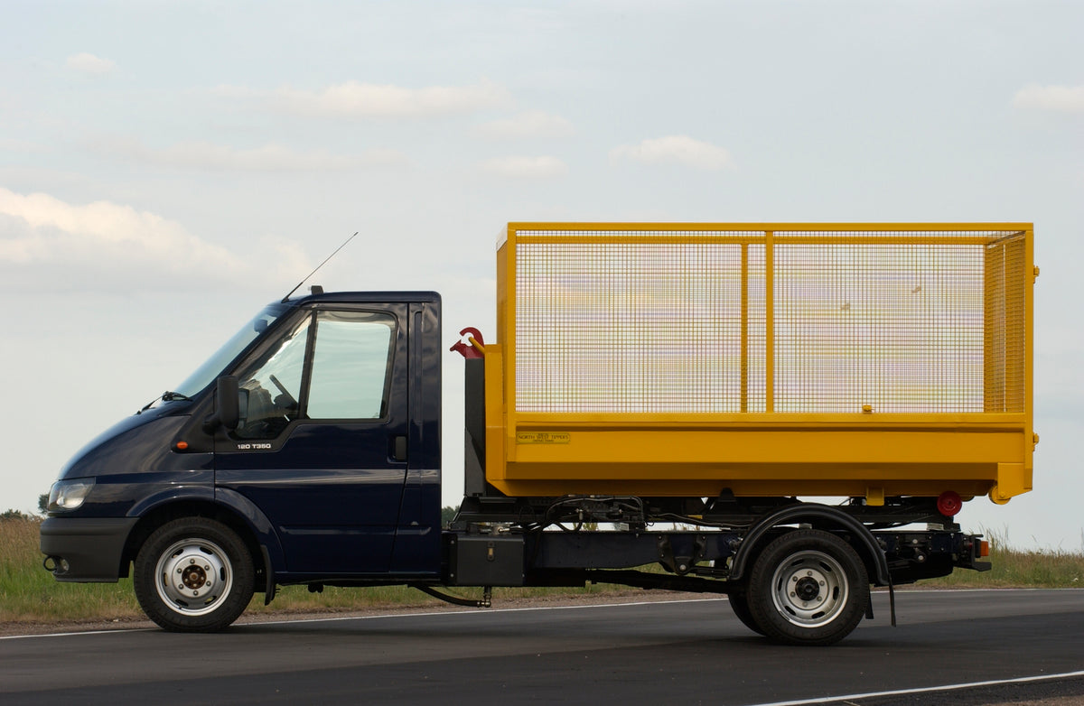 This archival image documents the 2003 Ford Transit Mark IV conversion with wire container side view on scenic road and is preserved in the Ford Heritage Vault as part of Ford Motor Company's historic photographic archive. Free for personal, non-c...
