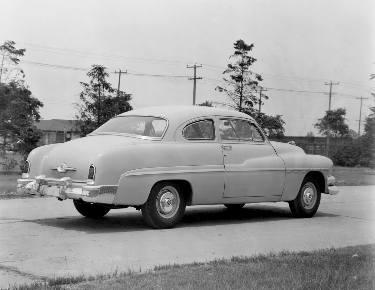 This archival image documents the 1951 Monarch Coupe rear view on scenic road with trees AR-2007-5 and is preserved in the Ford Heritage Vault as part of Ford Motor Company's historic photographic archive. Free for personal, non-commercial use. Fo...