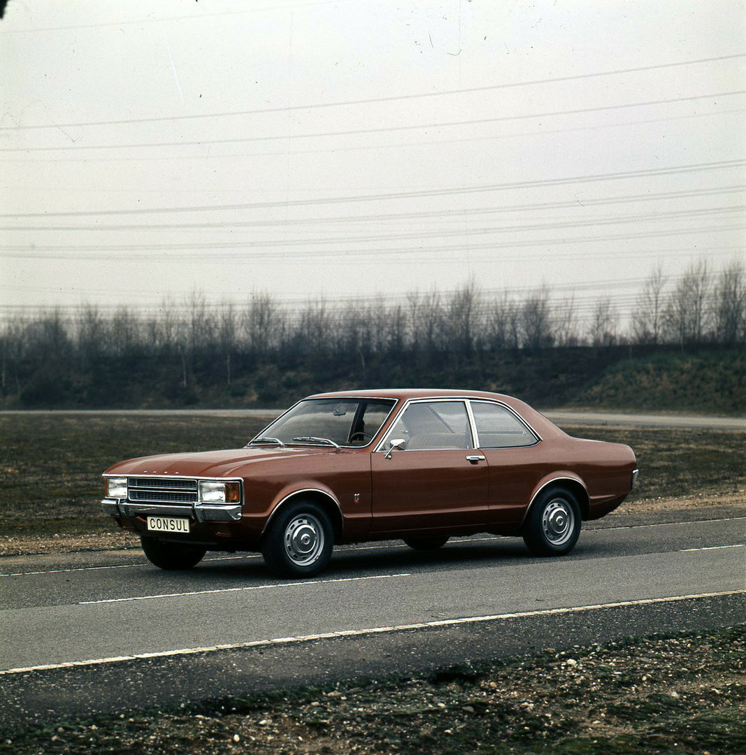 This archival image documents the 1973 Ford Consul on scenic road and is preserved in the Ford Heritage Vault as part of Ford Motor Company's historic photographic archive. Free for personal, non-commercial use. Ford Heritage Vault reference AR-20...