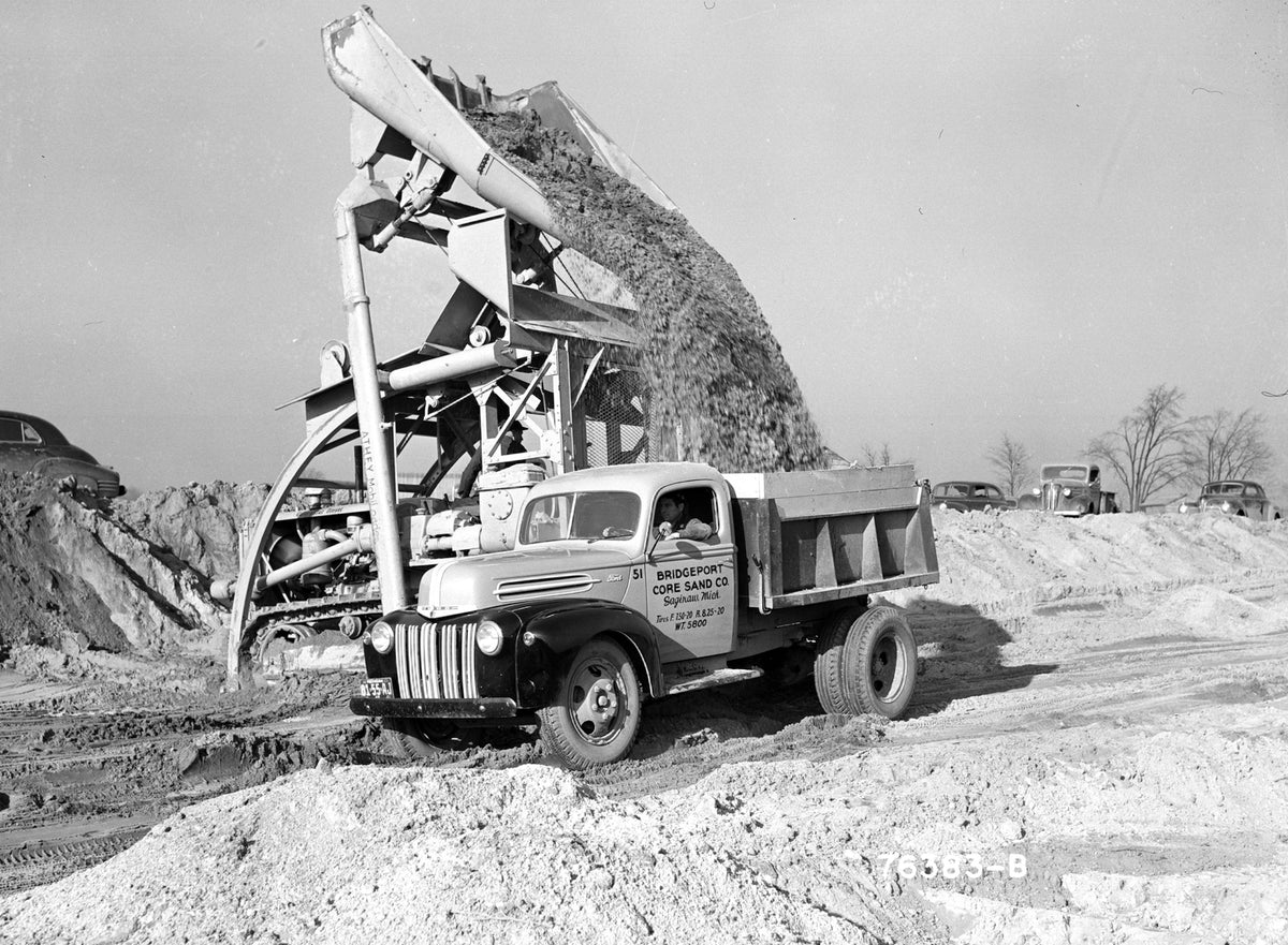 This archival image documents the 1942 Ford dump truck at construction site and is preserved in the Ford Heritage Vault as part of Ford Motor Company's historic photographic archive. Free for personal, non-commercial use. Ford Heritage Vault refer...