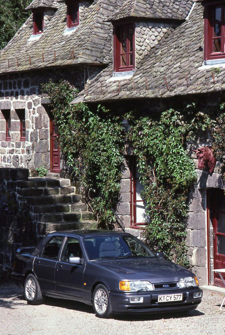 This archival image documents the 1987 Ford Sierra RS Cosworth in front of scenic building vertical shot and is preserved in the Ford Heritage Vault as part of Ford Motor Company's historic photographic archive. Free for personal, non-commercial u...