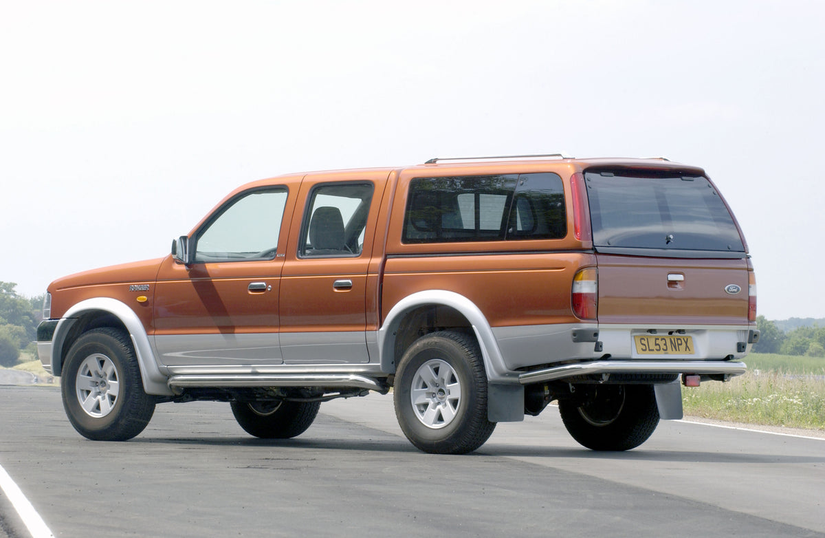 This archival image documents the 2003 Ford Ranger rear view on scenic road and is preserved in the Ford Heritage Vault as part of Ford Motor Company's historic photographic archive. Free for personal, non-commercial use. Ford Heritage Vault refer...