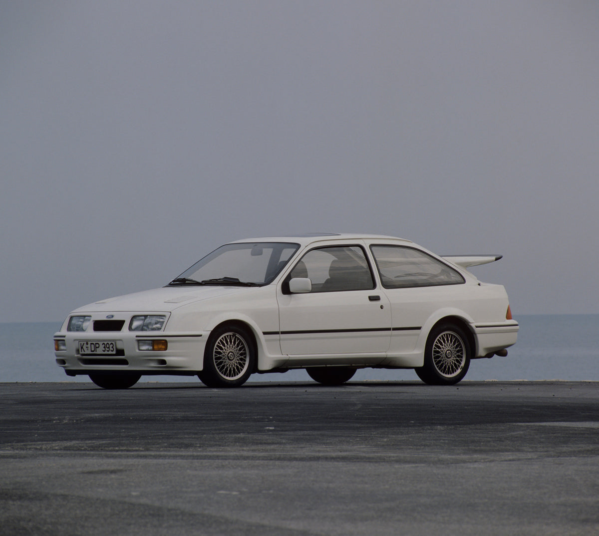 This archival image documents the 1985 Ford Sierra RS Cosworth with scenic blue sky and is preserved in the Ford Heritage Vault as part of Ford Motor Company's historic photographic archive. Free for personal, non-commercial use. Ford Heritage Vau...