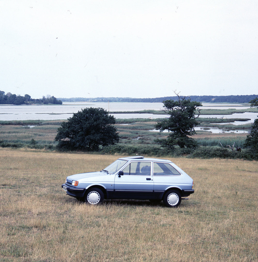 This archival image documents the 1984 Ford Fiesta Mark II Ghia in scenic field near waterway and is preserved in the Ford Heritage Vault as part of Ford Motor Company's historic photographic archive. Free for personal, non-commercial use. Ford He...