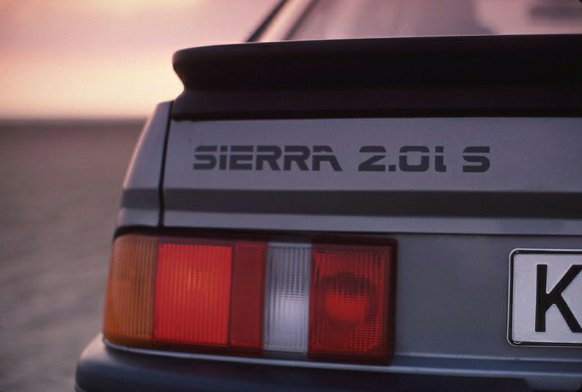 This archival image documents the 1985 Ford Sierra 2.0 IS LHD badge closeup and is preserved in the Ford Heritage Vault as part of Ford Motor Company's historic photographic archive. Free for personal, non-commercial use. Ford Heritage Vault refer...