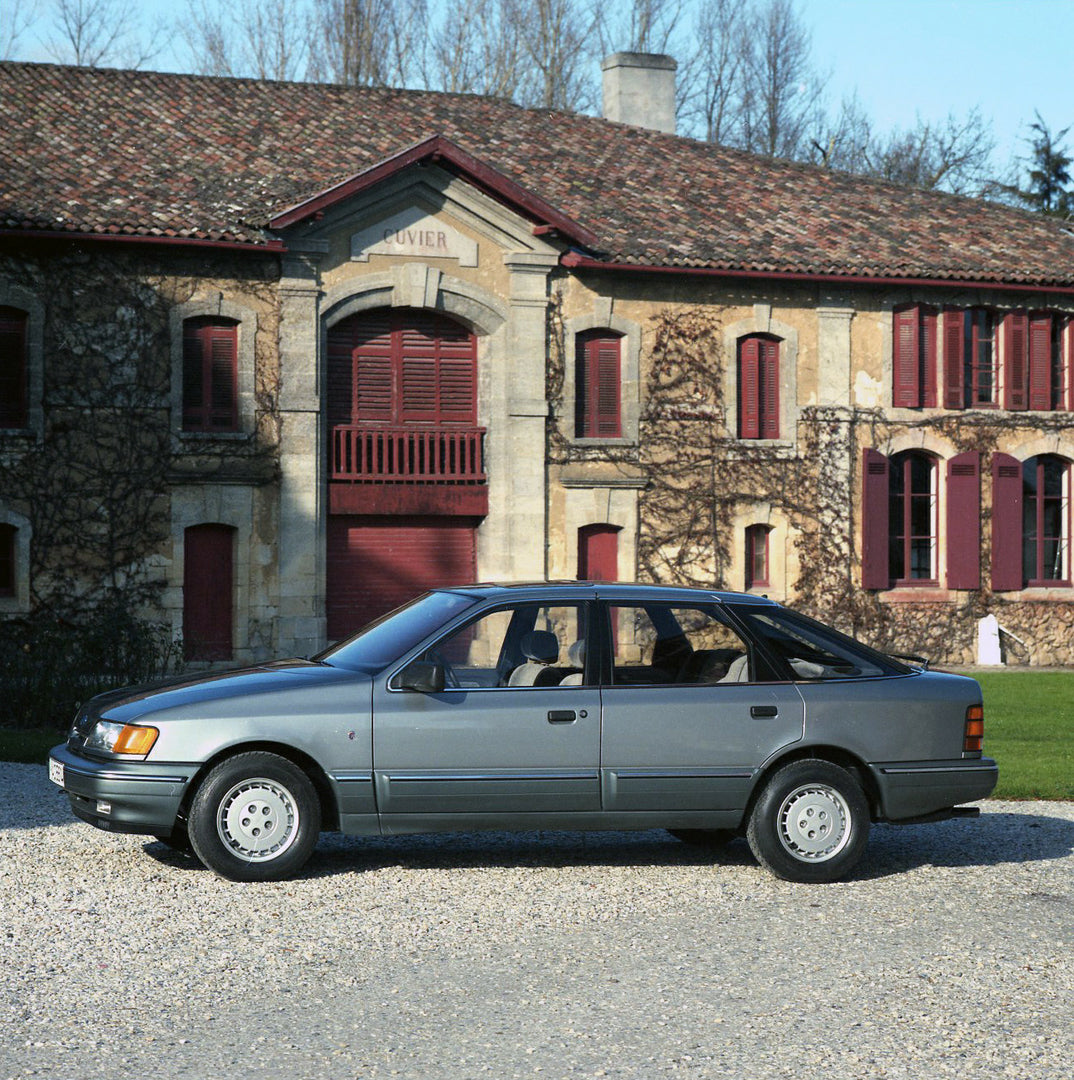 This archival image documents the 1984 Ford Scorpio Mark I LHD side view in front of scenic house in Bordeaux and is preserved in the Ford Heritage Vault as part of Ford Motor Company's historic photographic archive. Free for personal, non-commerc...