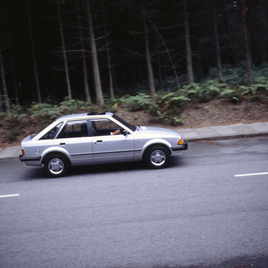 This archival image documents the 1980 Ford Escort Mark III action shot on forest road 1980-772001 and is preserved in the Ford Heritage Vault as part of Ford Motor Company's historic photographic archive. Free for personal, non-commercial use. Fo...