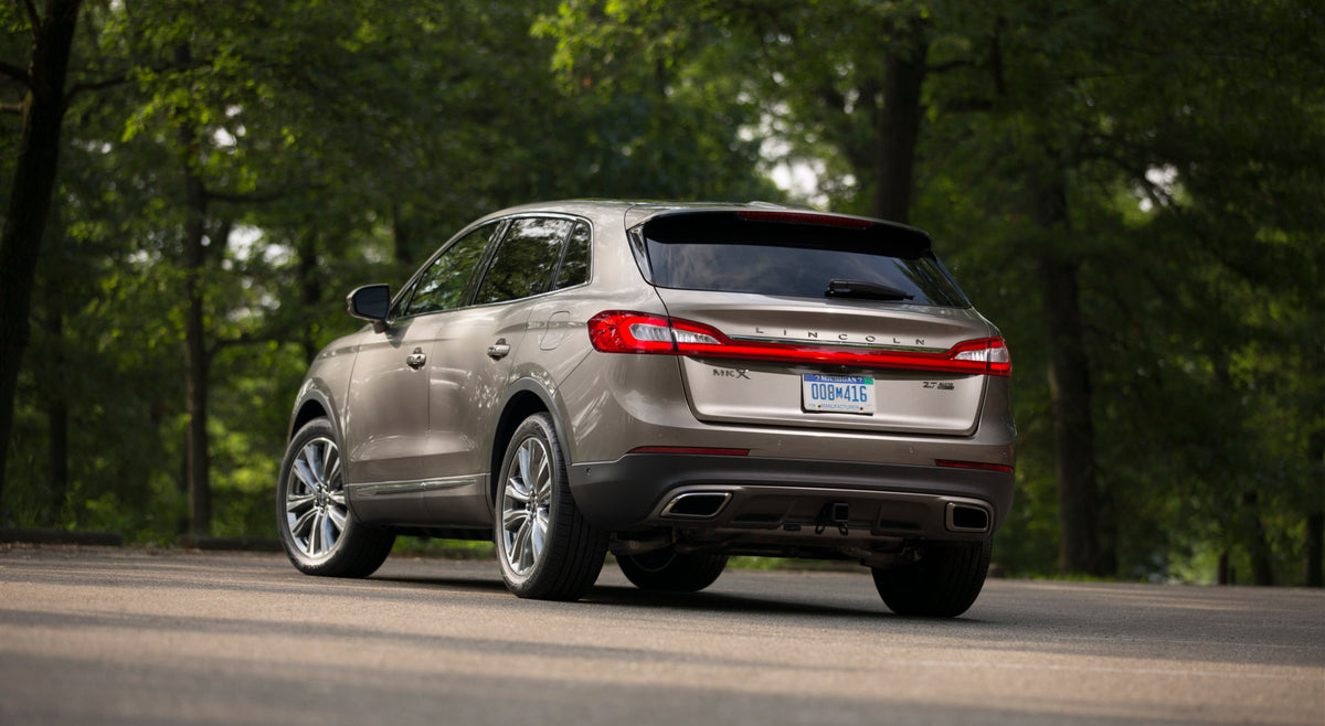 This archival image documents the 2016 Lincoln MKX rear view on scenic road and is preserved in the Ford Heritage Vault as part of Ford Motor Company's historic photographic archive. Free for personal, non-commercial use. Ford Heritage Vault refer...