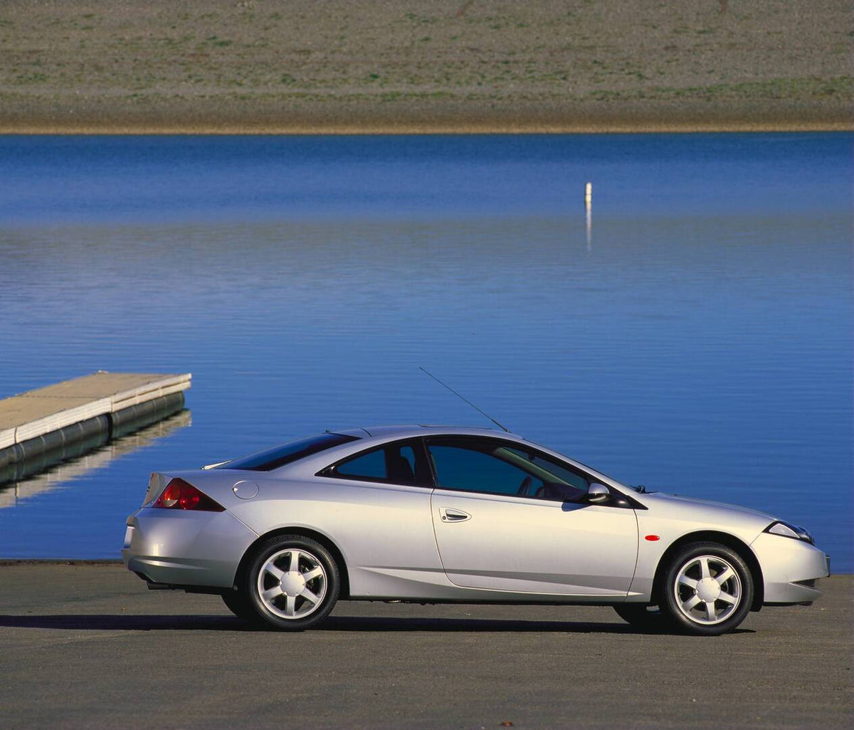 This archival image documents the 1998 Ford Cougar side view near scenic body of water AR-2002-213709 and is preserved in the Ford Heritage Vault as part of Ford Motor Company's historic photographic archive. Free for personal, non-commercial use....