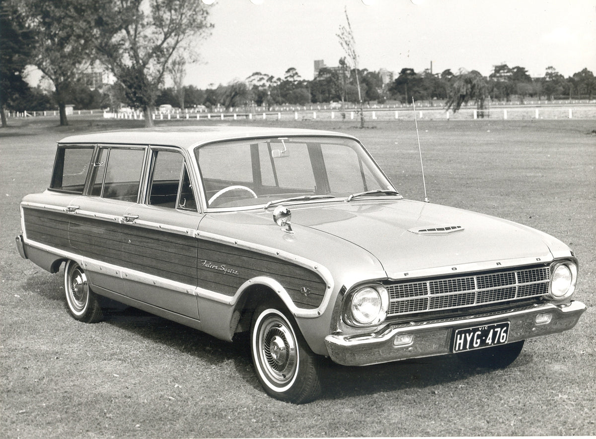 This archival image documents the 1964 Ford XM Falcon Squire Station Wagon in scenic field with trees and is preserved in the Ford Heritage Vault as part of Ford Motor Company's historic photographic archive. Free for personal, non-commercial use....