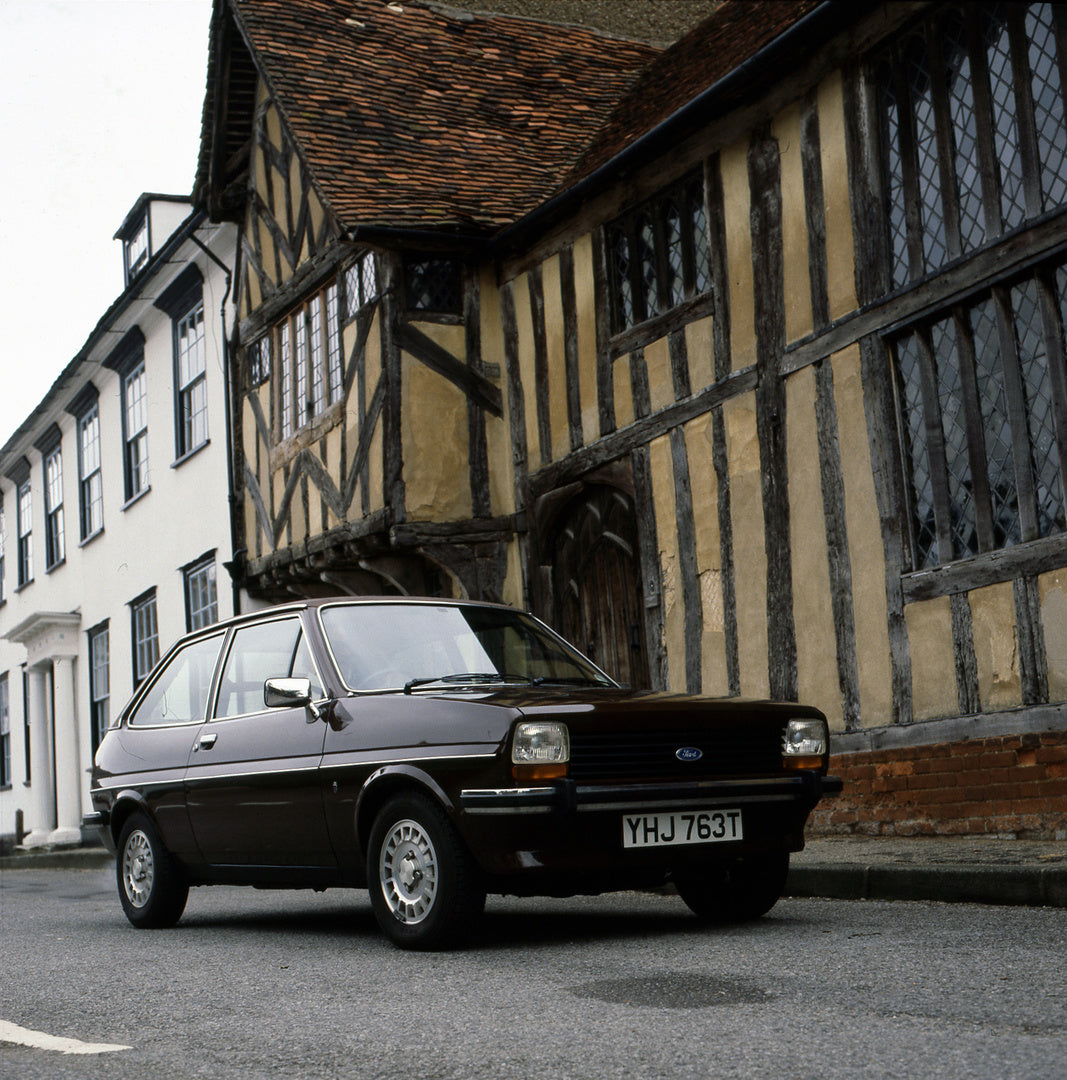 This archival image documents the 1978 Ford Fiesta Mark I Ghia on street in front of scenic historical building and is preserved in the Ford Heritage Vault as part of Ford Motor Company's historic photographic archive. Free for personal, non-comme...