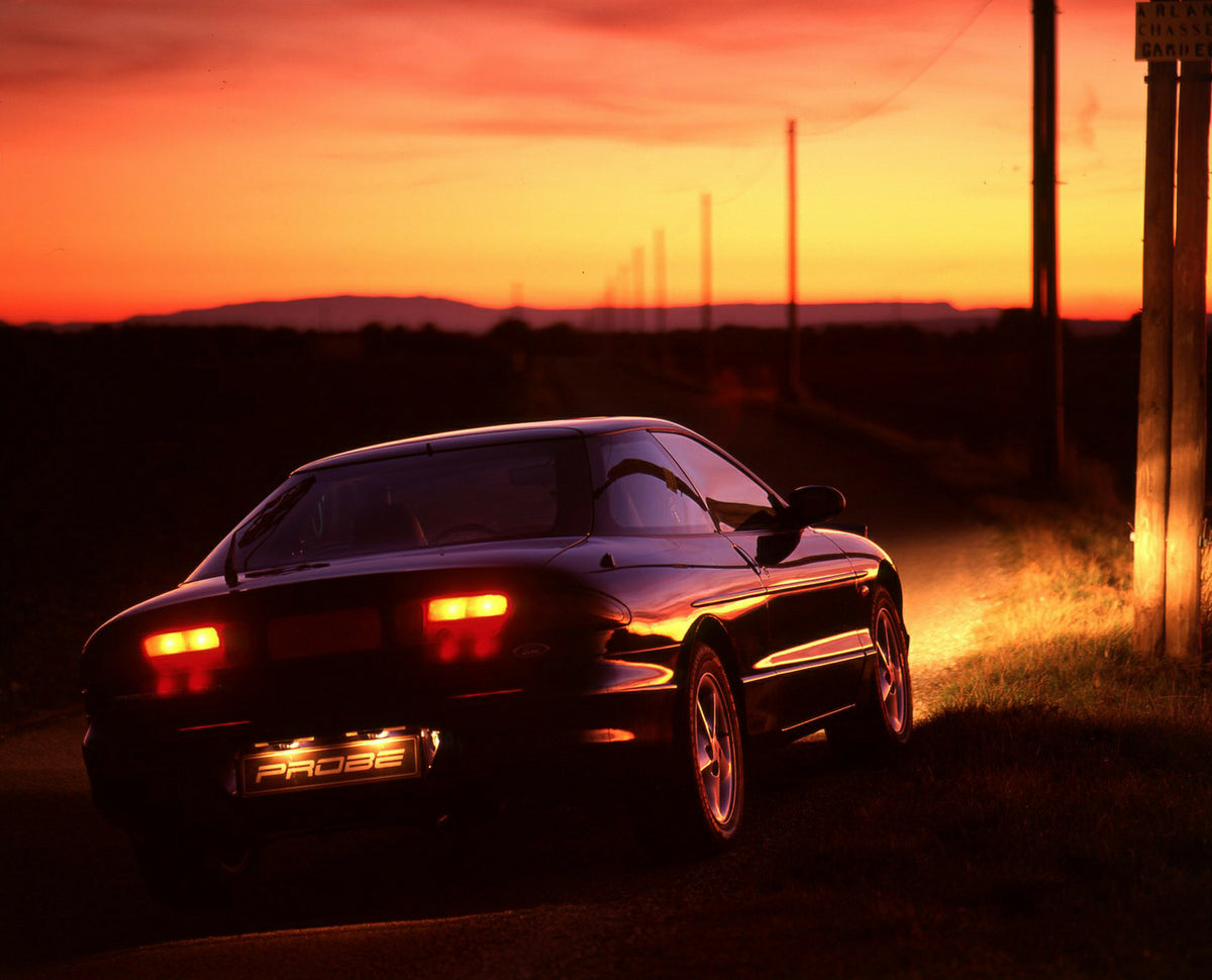 This archival image documents the 1993 Ford Probe Mark II at night on scenic road and is preserved in the Ford Heritage Vault as part of Ford Motor Company's historic photographic archive. Free for personal, non-commercial use. Ford Heritage Vault...