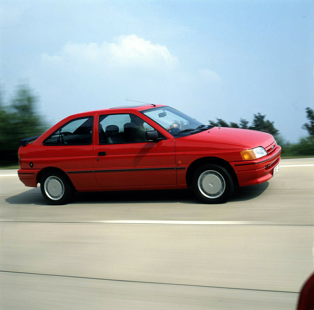 This archival image documents the 1990 Ford Escort S Mark IV on road in Lommel, Belgium and is preserved in the Ford Heritage Vault as part of Ford Motor Company's historic photographic archive. Free for personal, non-commercial use. Ford Heritage...