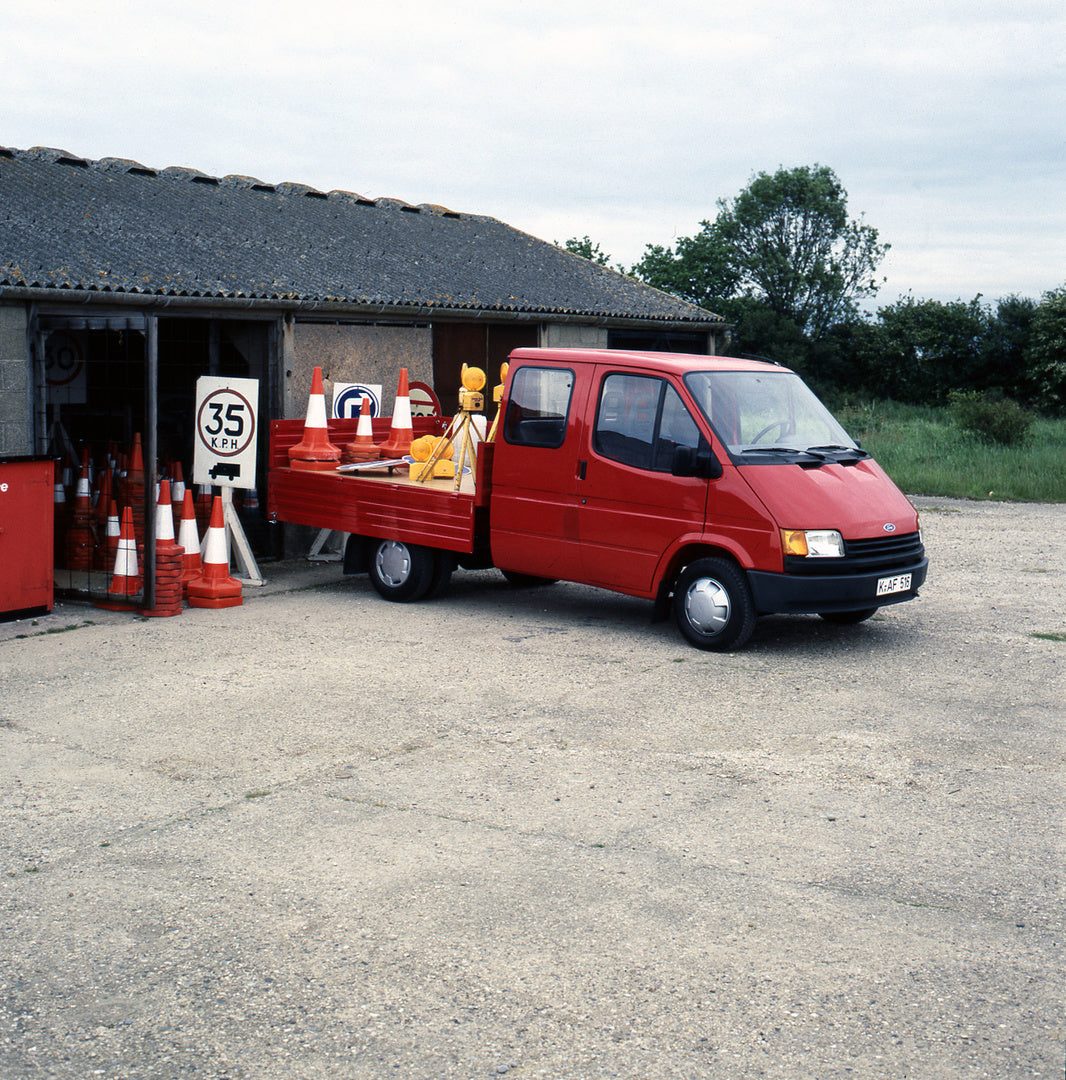 This archival image documents the 1986 Ford Transit Mark III VE 6 Double Cab Float LHD near building with cones and is preserved in the Ford Heritage Vault as part of Ford Motor Company's historic photographic archive. Free for personal, non-comme...