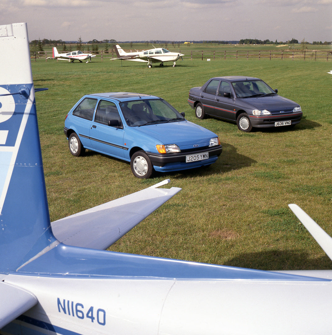 This archival image documents the 1991 Ford Fiesta Mark III 1.1 LX and Ford Escort Mark IV with planes and is preserved in the Ford Heritage Vault as part of Ford Motor Company's historic photographic archive. Free for personal, non-commercial use...