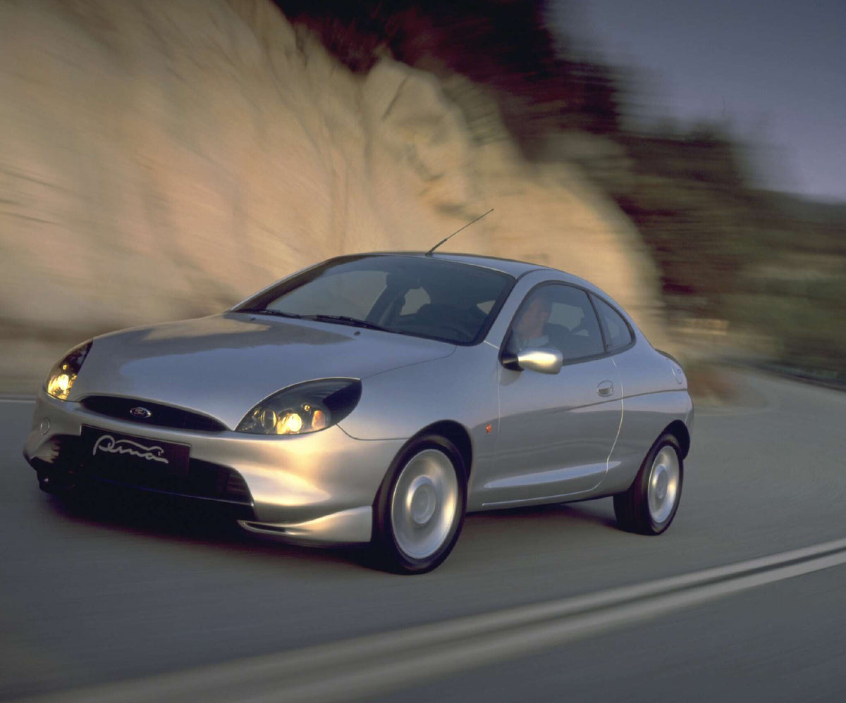 This archival image documents the 1997 Ford Puma action shot on scenic road AR-2002-213709 and is preserved in the Ford Heritage Vault as part of Ford Motor Company's historic photographic archive. Free for personal, non-commercial use. Ford Herit...
