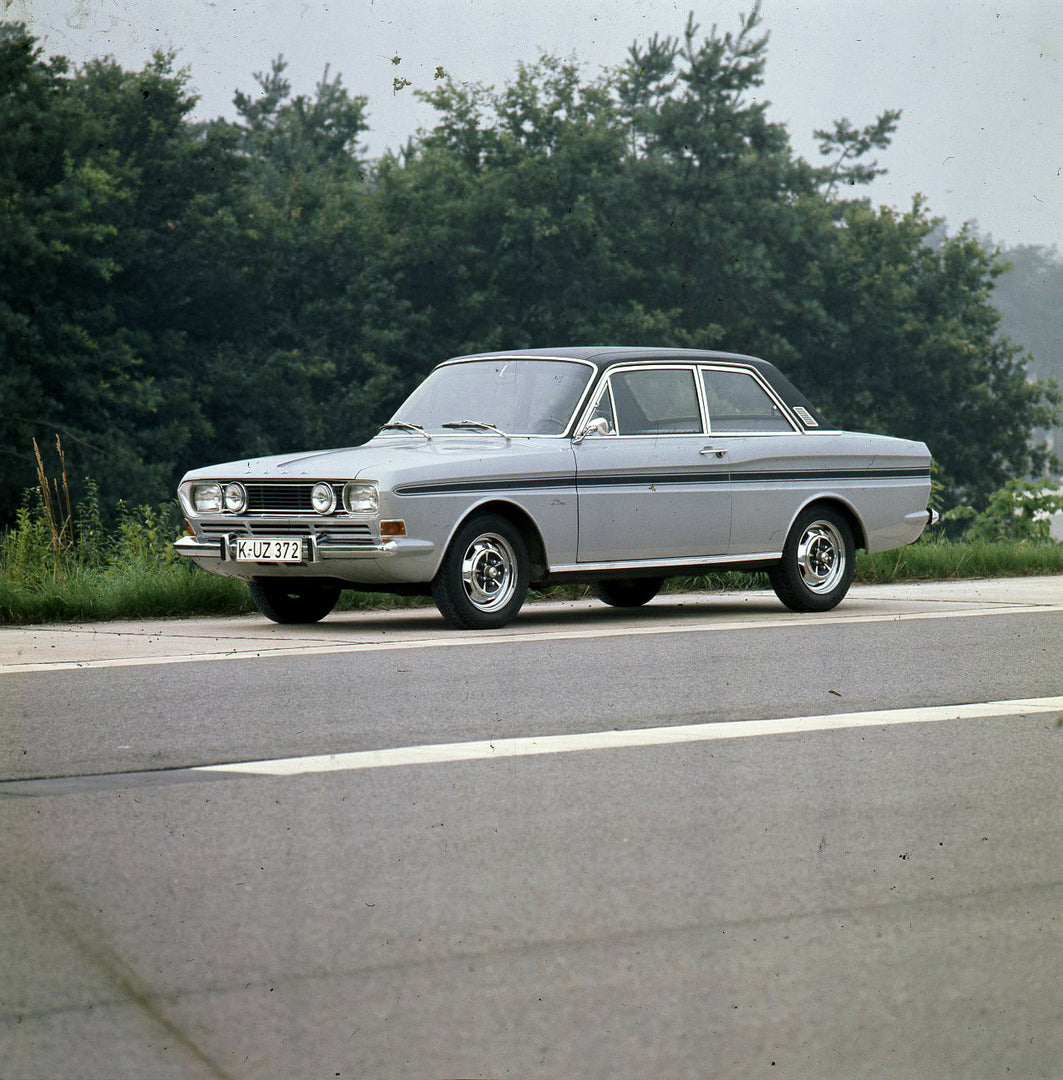 This archival image documents the 1970 Ford Taunus on scenic road with trees and is preserved in the Ford Heritage Vault as part of Ford Motor Company's historic photographic archive. Free for personal, non-commercial use. Ford Heritage Vault refe...