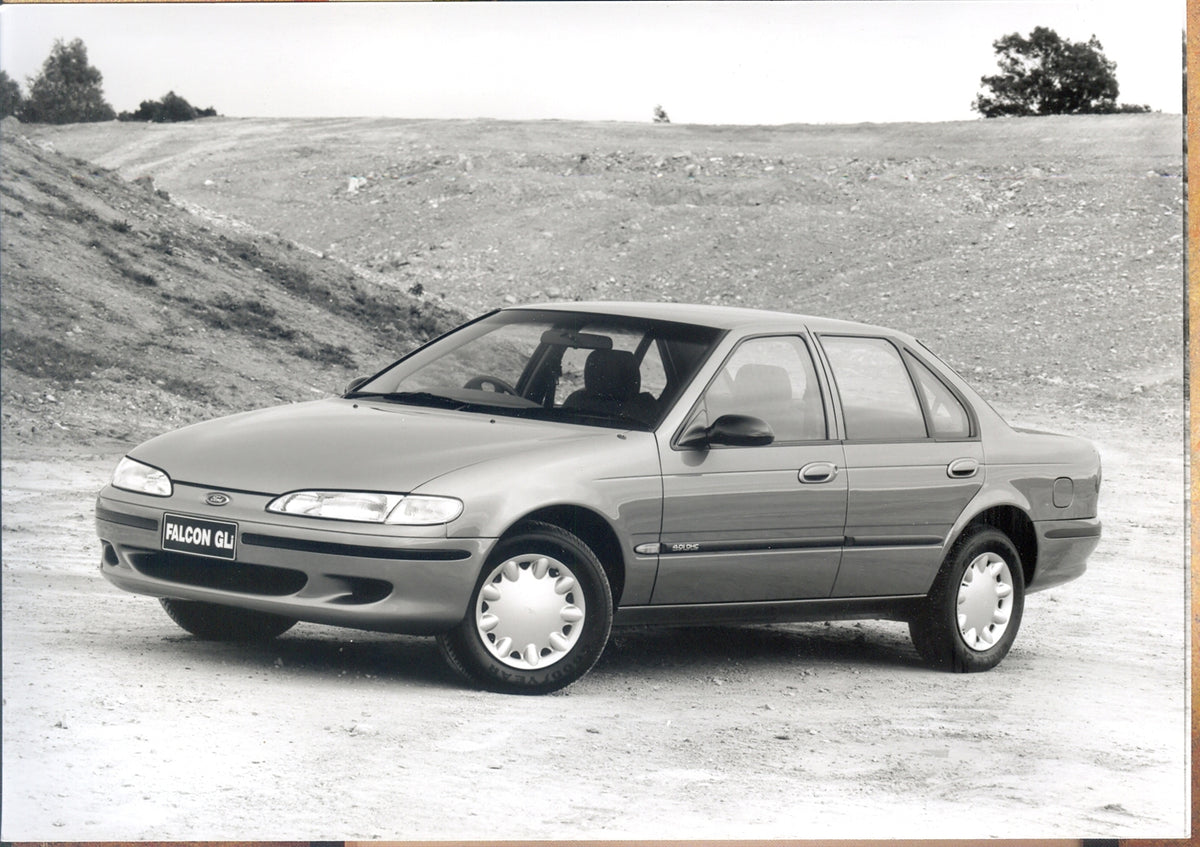 This archival image documents the 1995 Ford Falcon EF GLi Series II with scenic hills and is preserved in the Ford Heritage Vault as part of Ford Motor Company's historic photographic archive. Free for personal, non-commercial use. Ford Heritage V...