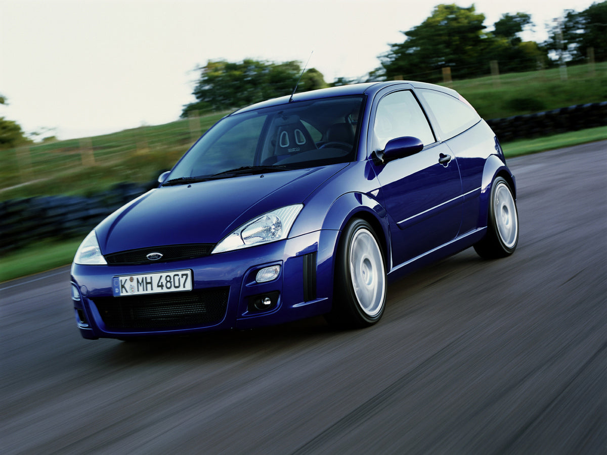 This archival image documents the 2001 Ford Focus action shot on scenic road with trees and is preserved in the Ford Heritage Vault as part of Ford Motor Company's historic photographic archive. Free for personal, non-commercial use. Ford Heritage...