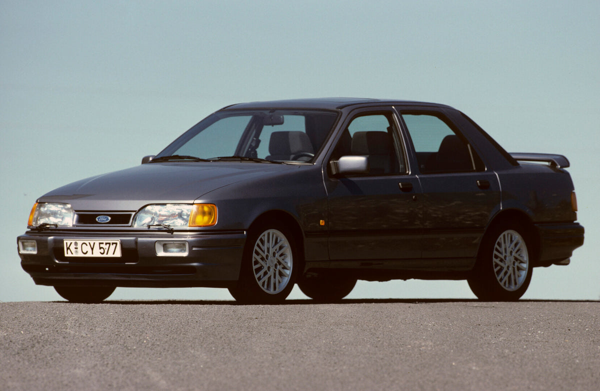 This archival image documents the 1988 Ford Sierra RS Cosworth with scenic blue sky and is preserved in the Ford Heritage Vault as part of Ford Motor Company's historic photographic archive. Free for personal, non-commercial use. Ford Heritage Vau...
