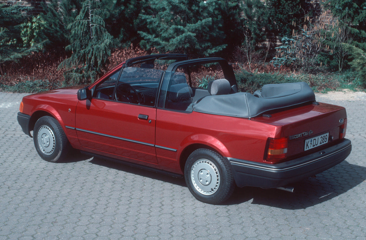 This archival image documents the 1987 Ford Escort Mark IV rear view with scenic trees Escort_Cabrio_Ghia_1987_04 and is preserved in the Ford Heritage Vault as part of Ford Motor Company's historic photographic archive. Free for personal, non-com...