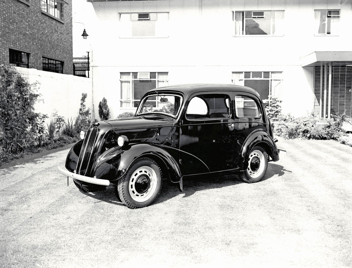 This archival image documents the 1953 Ford Popular 103E front 3/4 view in front of building 1953-59-3526 and is preserved in the Ford Heritage Vault as part of Ford Motor Company's historic photographic archive. Free for personal, non-commercial ...