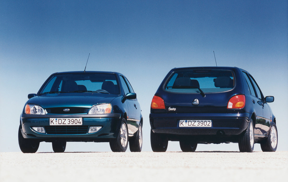 This archival image documents the 1999 Ford Fiesta Mark IV front and rear view with scenic blue sky and is preserved in the Ford Heritage Vault as part of Ford Motor Company's historic photographic archive. Free for personal, non-commercial use. F...
