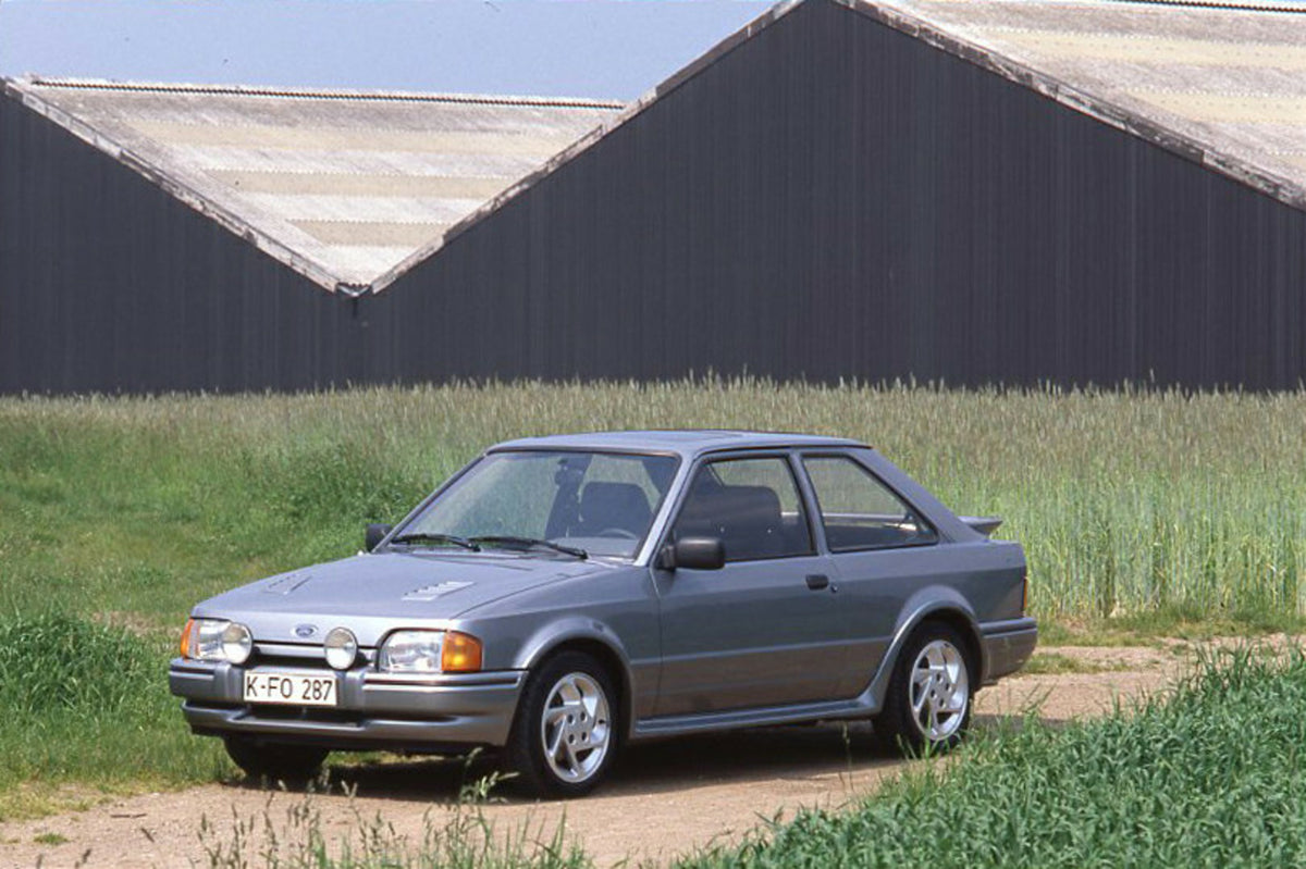 This archival image documents the 1986 Ford Escort Mark IV Turbo LHD in front of scenic barn and is preserved in the Ford Heritage Vault as part of Ford Motor Company's historic photographic archive. Free for personal, non-commercial use. Ford Her...