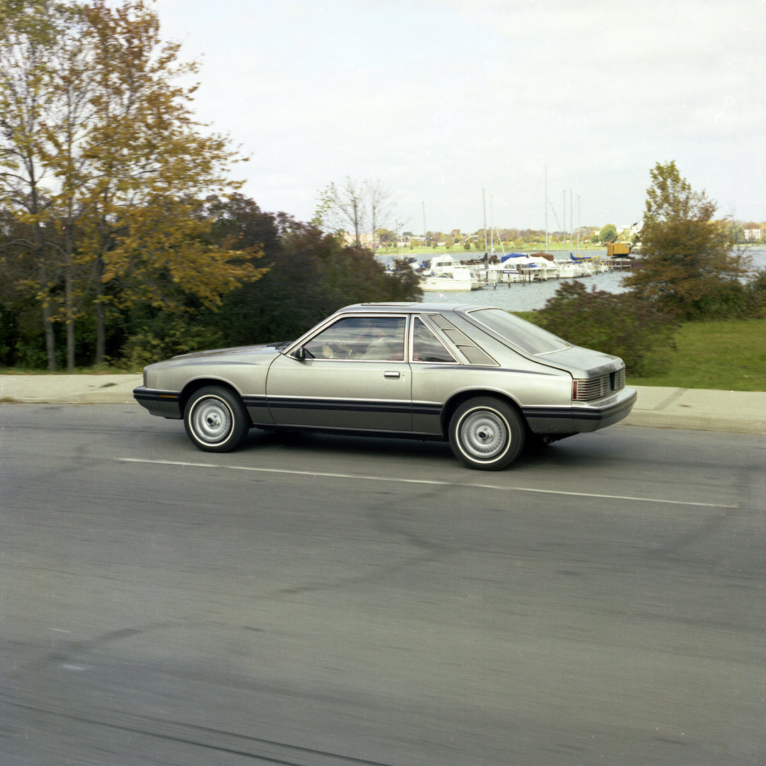 This archival image documents the 1981 Mercury Capri with Marina in Background and is preserved in the Ford Heritage Vault as part of Ford Motor Company's historic photographic archive. Free for personal, non-commercial use. Ford Heritage Vault re...