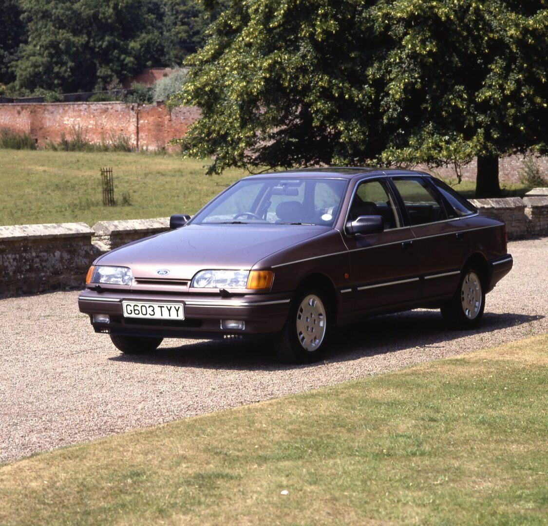 This archival image documents the 1989 Ford Granada Scorpio Mark III closeup on scenic road and is preserved in the Ford Heritage Vault as part of Ford Motor Company's historic photographic archive. Free for personal, non-commercial use. Ford Heri...