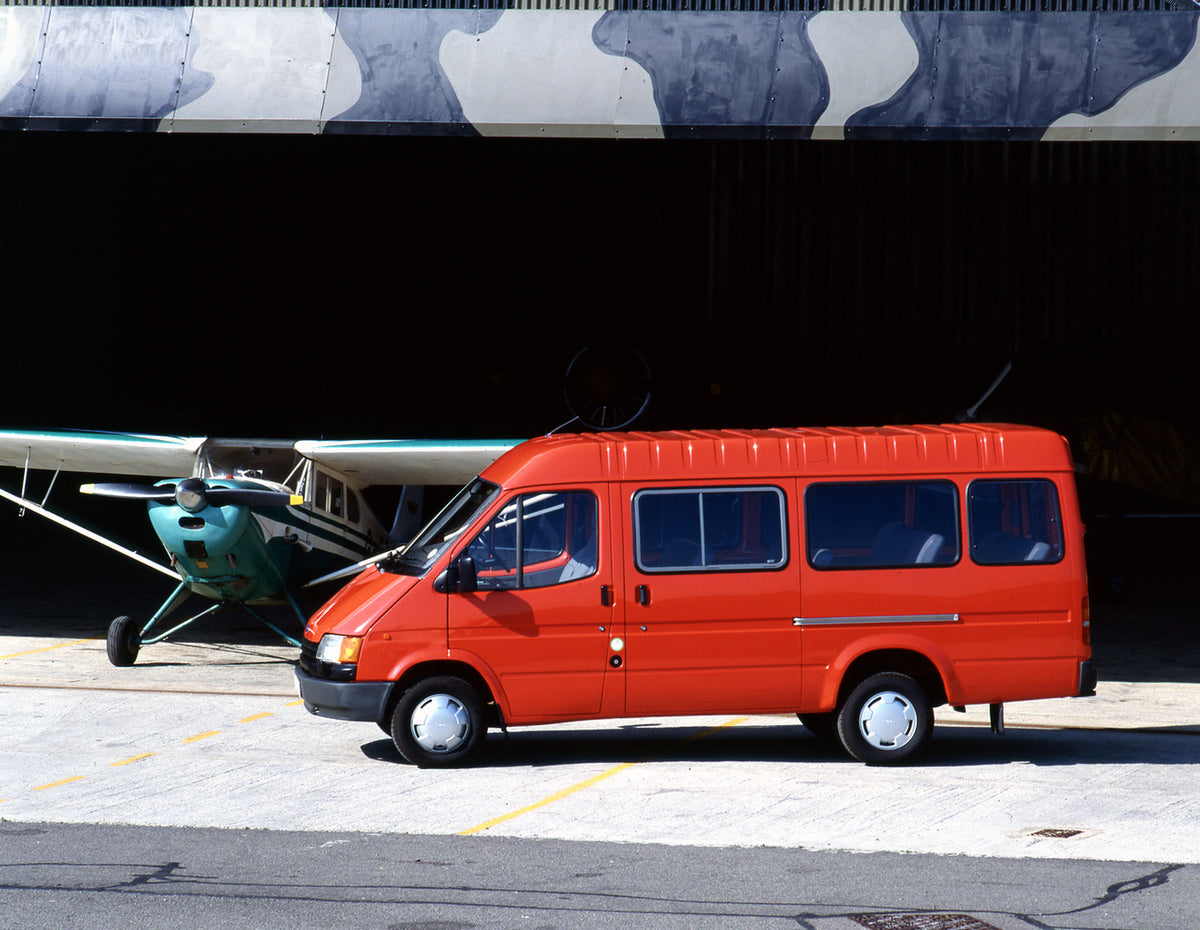 This archival image documents the 1990 Ford Transit Mark III Bus side view with plane and is preserved in the Ford Heritage Vault as part of Ford Motor Company's historic photographic archive. Free for personal, non-commercial use. Ford Heritage V...