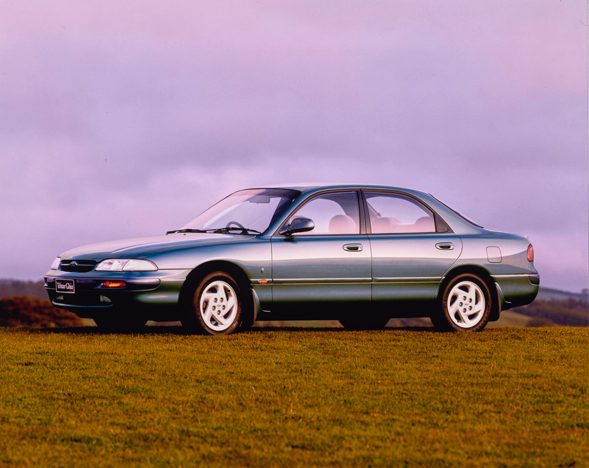 This archival image documents the 1990 Ford Telstar Ghia Sedan Passenger Side Front End View in a Field FAP-2011-3 and is preserved in the Ford Heritage Vault as part of Ford Motor Company's historic photographic archive. Free for personal, non-co...