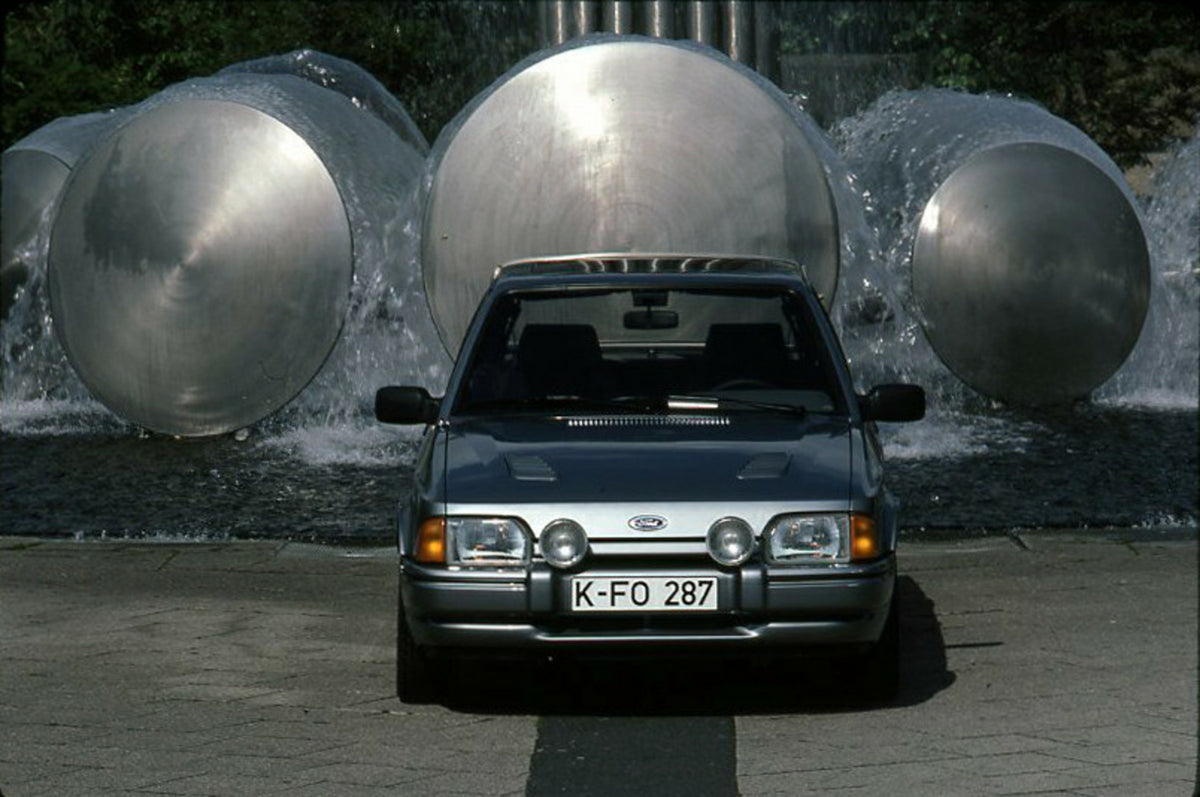 This archival image documents the 1986 Ford Escort Mark IV Turbo LHD front view in front of sculpture and is preserved in the Ford Heritage Vault as part of Ford Motor Company's historic photographic archive. Free for personal, non-commercial use....