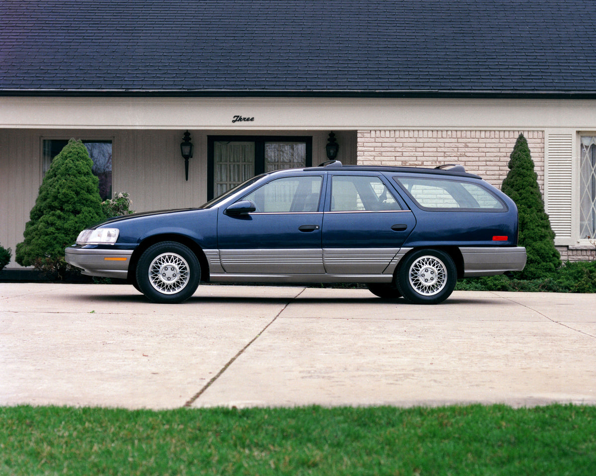This archival image documents the 1990 Mercury Sable station wagon in Front of Home and is preserved in the Ford Heritage Vault as part of Ford Motor Company's historic photographic archive. Free for personal, non-commercial use. Ford Heritage Vau...