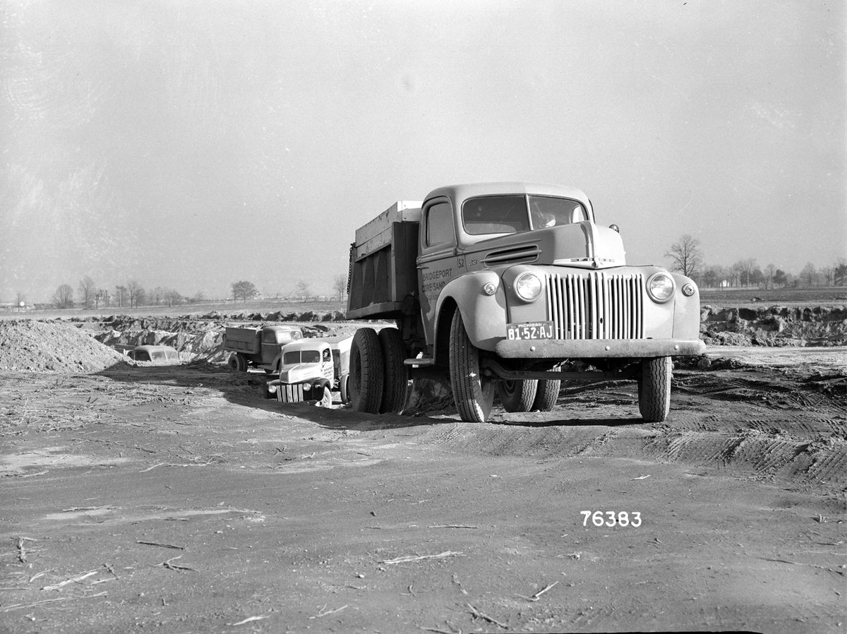 This archival image documents the 1942 Ford dump truck at construction site and is preserved in the Ford Heritage Vault as part of Ford Motor Company's historic photographic archive. Free for personal, non-commercial use. Ford Heritage Vault refer...