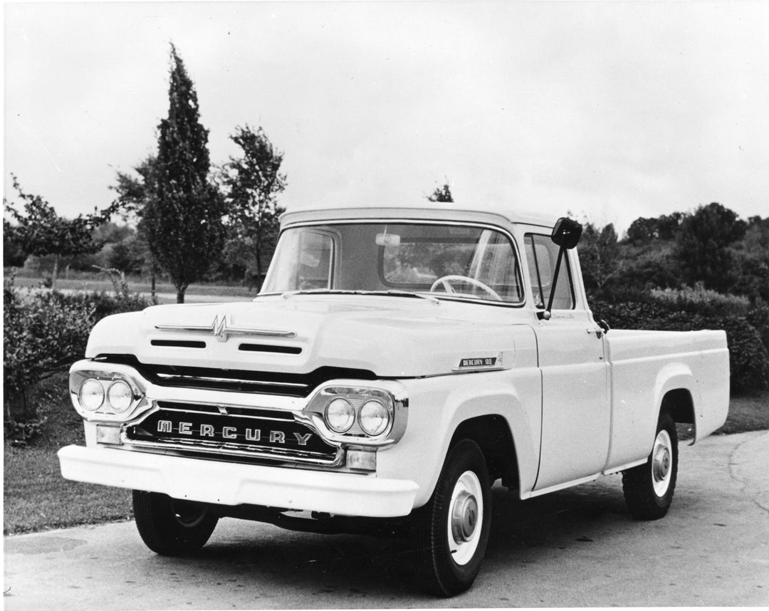 This archival image documents the 1960 Mercury M-100 on scenic road with trees and is preserved in the Ford Heritage Vault as part of Ford Motor Company's historic photographic archive. Free for personal, non-commercial use. Ford Heritage Vault re...
