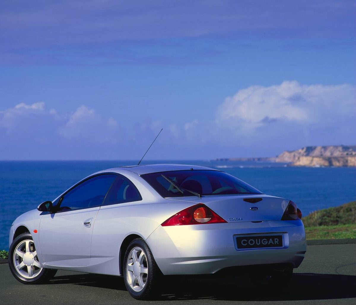 This archival image documents the 1998 Ford Cougar rear view near scenic body of water AR-2002-213709 and is preserved in the Ford Heritage Vault as part of Ford Motor Company's historic photographic archive. Free for personal, non-commercial use....